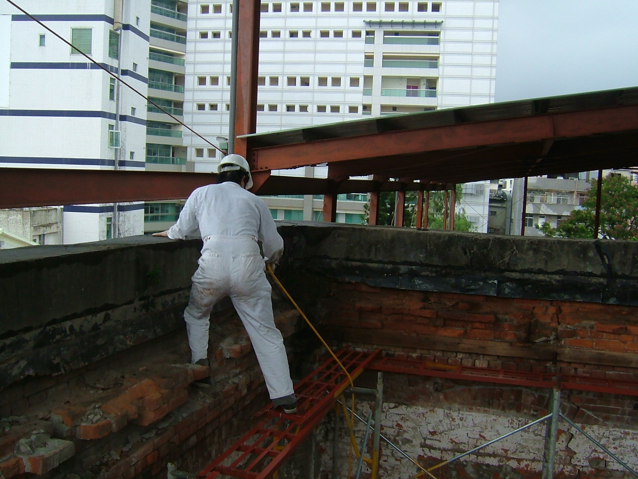 Pest control worker inspecting wooden ceiling